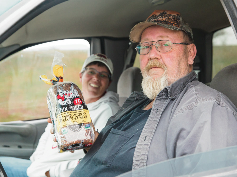 Husband and Wife Holding Food in Car