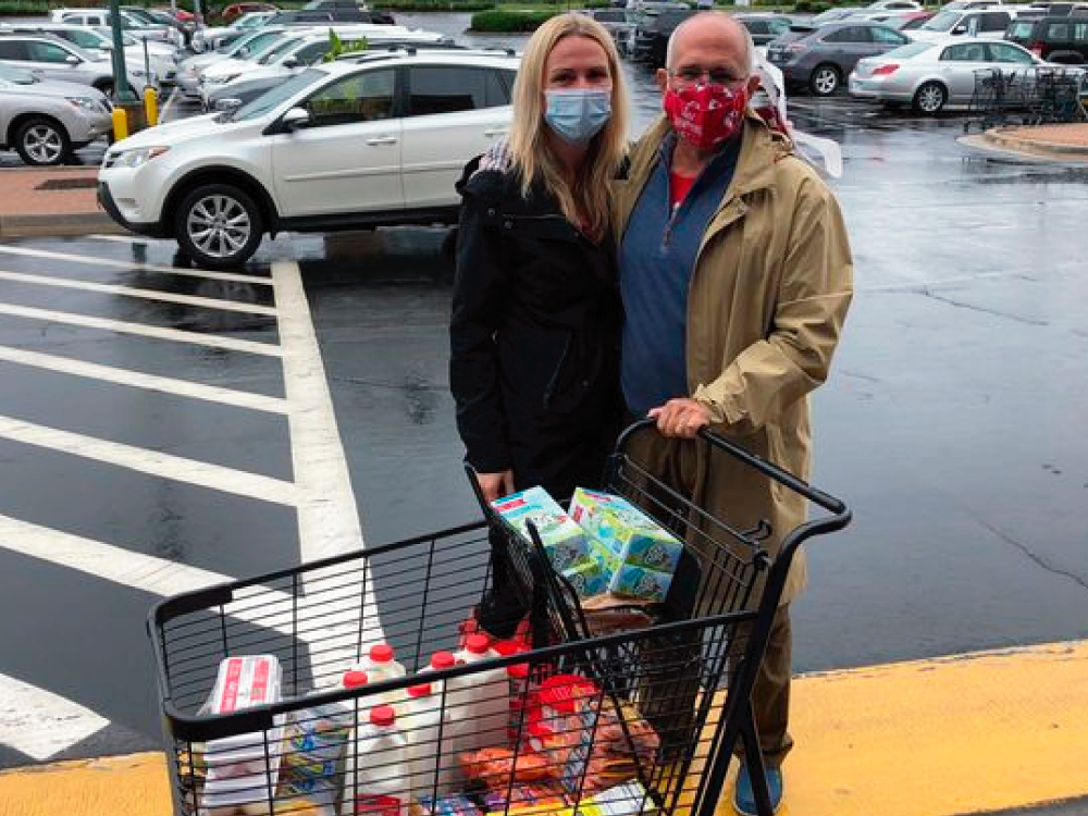 Couple with Food Donations at Fill the Fridge
