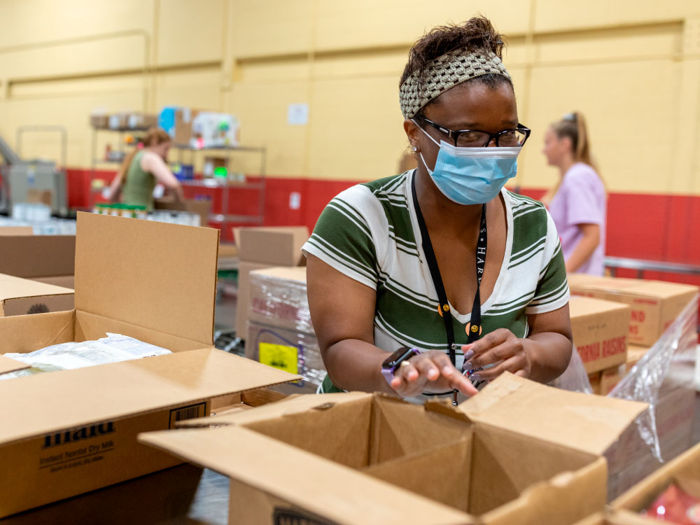 Woman Packing Box in Warehouse
