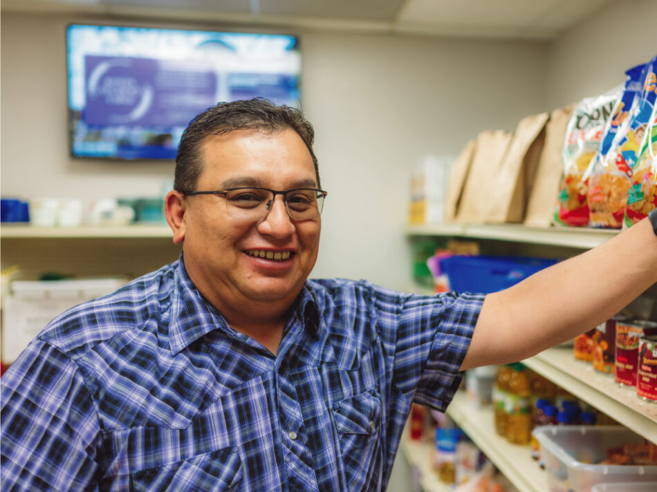 Man Leaning Against Food Shelf