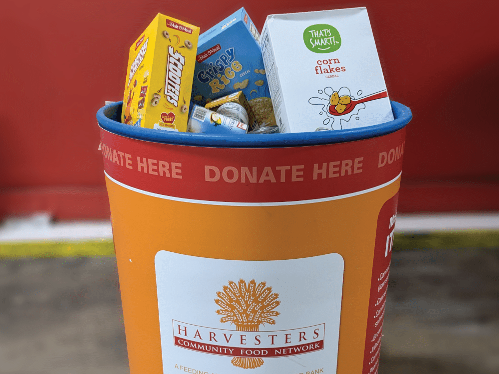 Harvesters donation barrel filled with cereal boxes and food donations.